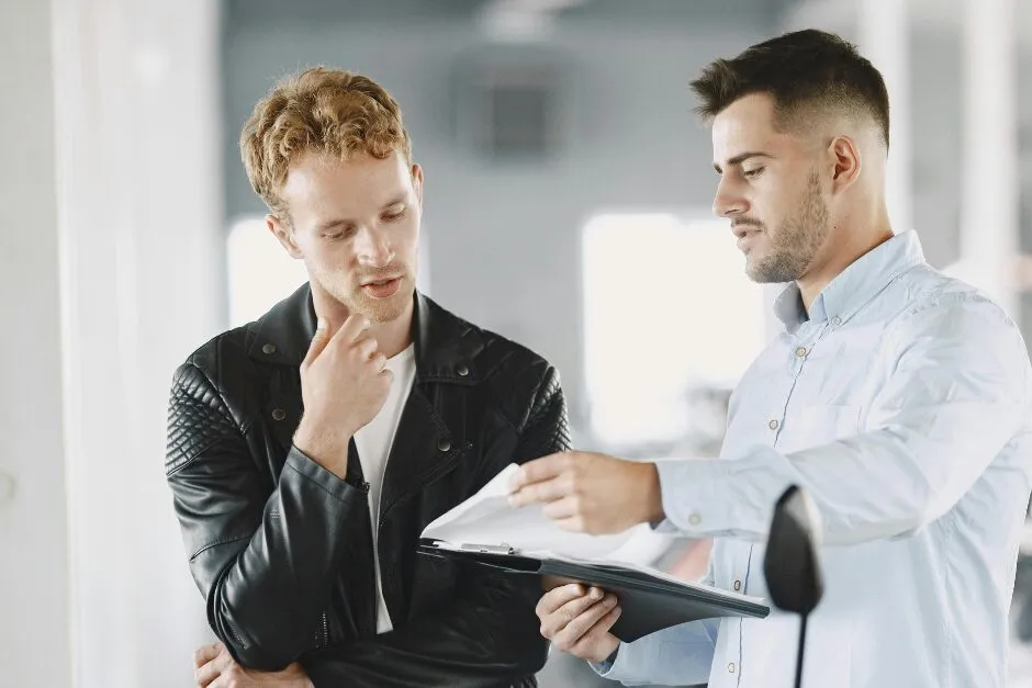 Two people reviewing insurance paperwork together