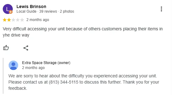 A two-star Google review about unit access with a reply from the storage operator