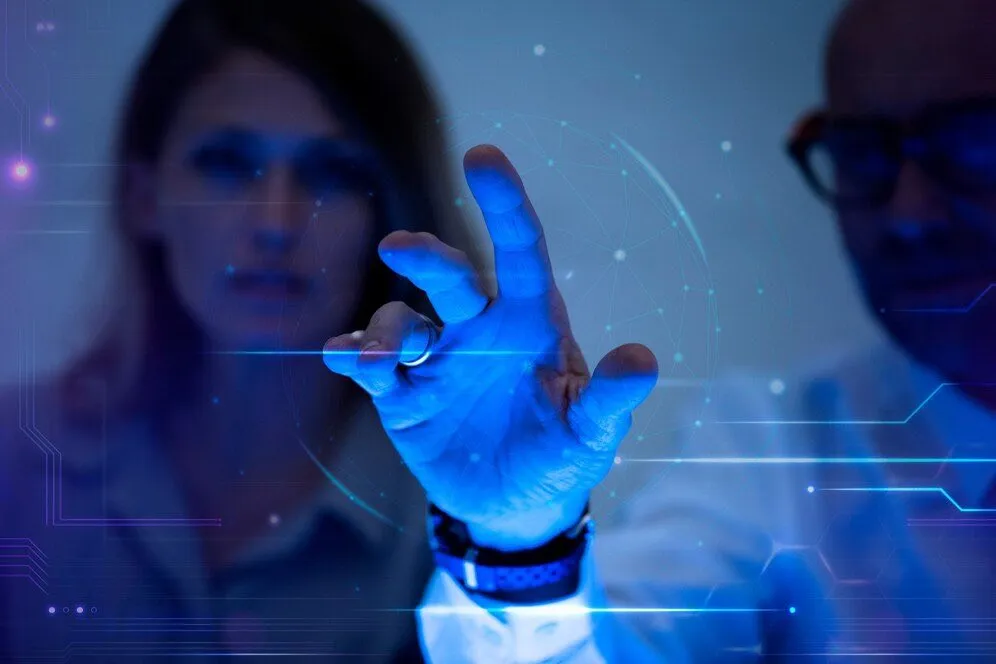 A hand reaching towards a glowing blue digital interface