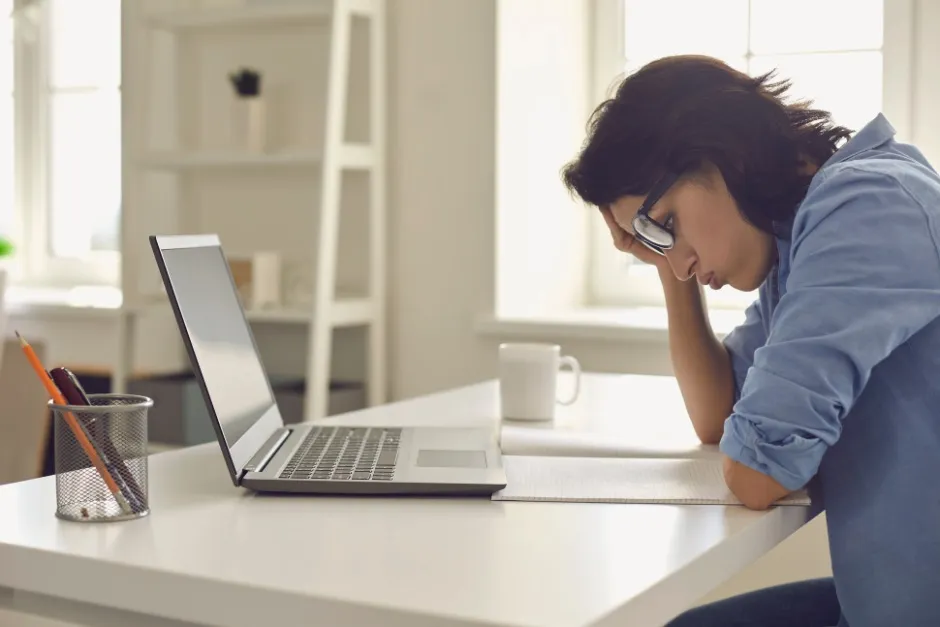 A self storage operator looking frustrated at a laptop