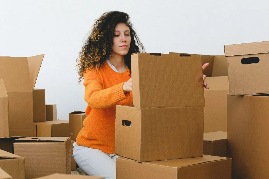 A customer packing belongings into boxes ready for storage