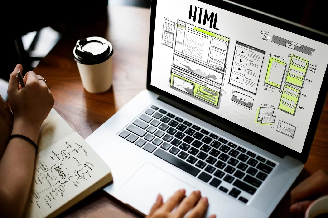 A laptop showing a web page wireframe layout