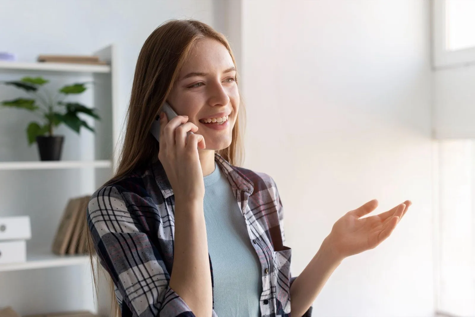 A woman smiling while taking a customer call on her mobile phone