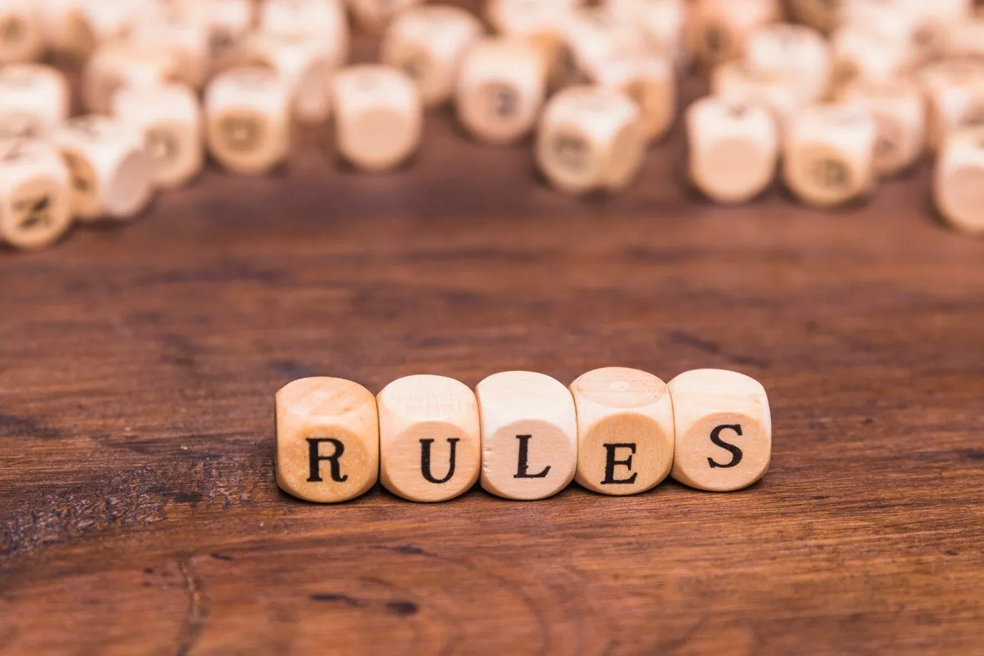 Wooden dice arranged to spell the word rules